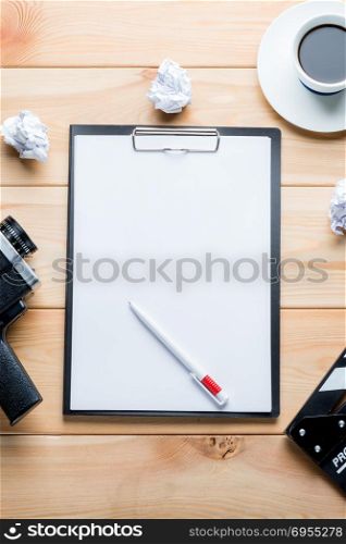 paper and objects for the film industry on a wooden background top view