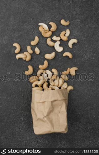 paper bag filled with healthy raw cashew nuts. Resolution and high quality beautiful photo. paper bag filled with healthy raw cashew nuts. High quality and resolution beautiful photo concept