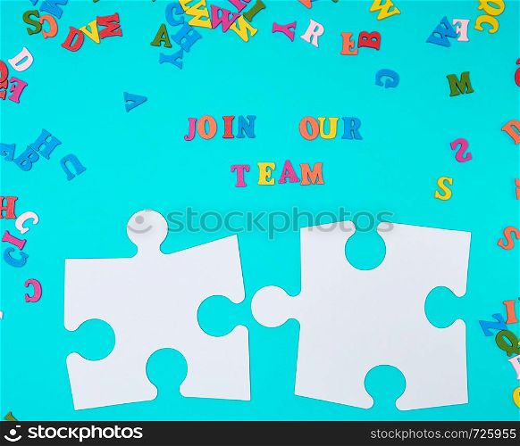 paper blank white puzzle on a blue background, inscription join our team, concept of recruitment. Teamwork business concept