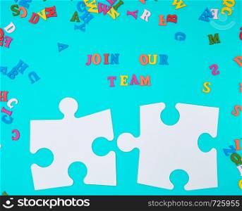 paper blank white puzzle on a blue background, inscription join our team, concept of recruitment. Teamwork business concept