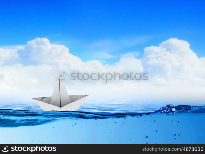 Paper boat. Paper boat sailing on blue water surface