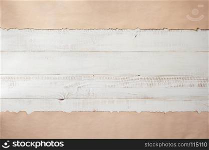 paper border at white plank wooden background