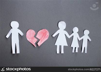 Paper chain cut family with broken heart on gray background. Divorce and broken family concept.. Paper chain cut family with broken heart on gray background. Divorce and broken family concept