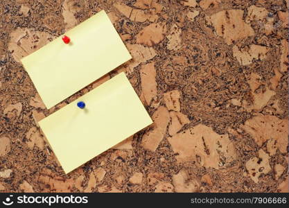 paper clip and push pin on cork noticeboard