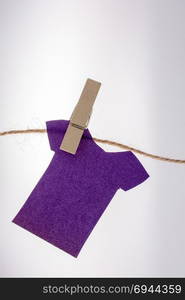 Paper clothes hang on a rope with the help of clothespins