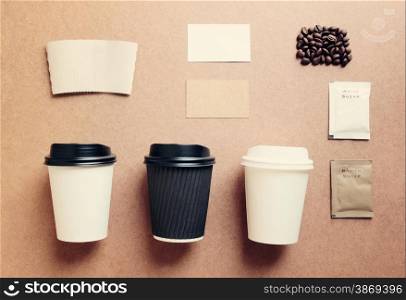 Paper coffee cup mock up for identity branding from top view with retro filter effect