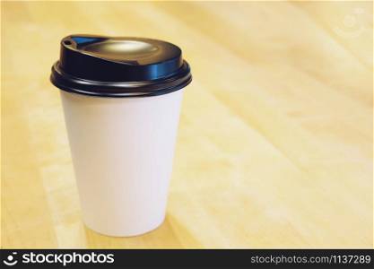 Paper cup of take away drinking coffee hot on cafe coffee shop.