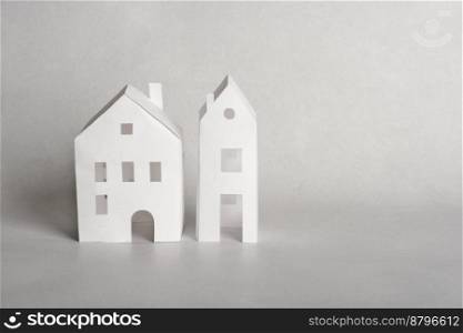 paper cut houses models on a grey background. house purchase or mortgage, loan or insurance. house for sale. paper cut houses models on a grey background. house purchase or mortgage, loan or insurance. house for sale.