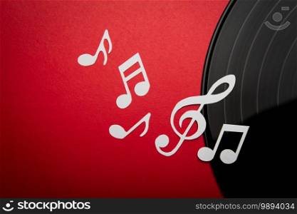 Paper cut of music note on Black vinyl record lp album disc with copy space for text or design