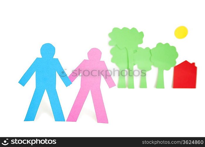 Paper cut outs representing a couple with trees and house over white background