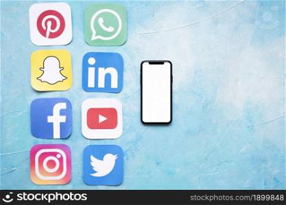 paper cut outs social media icons arranged near smartphone. Resolution and high quality beautiful photo. paper cut outs social media icons arranged near smartphone. High quality beautiful photo concept