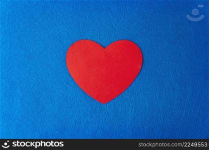Paper cut red heart shape on blue textured background with copy space. Concept image. Valentine&rsquo;s day, mother&rsquo;s day, birthday greeting cards, invitation, celebration