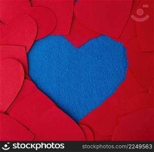 Paper cut red hearts frame on blue textured background with copy space. Concept image. Valentine&rsquo;s day, mother&rsquo;s day, birthday greeting cards, invitation, celebration