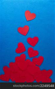 Paper cut red hearts shape on blue textured background with copy space. Concept image. Valentine&rsquo;s day, mother&rsquo;s day, birthday greeting cards, invitation, celebration