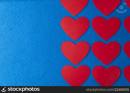 Paper cut red hearts shape on blue textured background with copy space. Concept image. Valentine&rsquo;s day, mother&rsquo;s day, birthday greeting cards, invitation, celebration