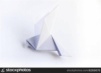 Paper dove origami isolated on a blank white background.. Paper dove origami isolated on a white background