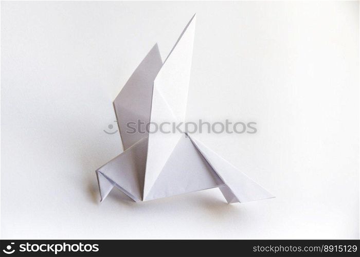 Paper dove origami isolated on a blank white background.. Paper dove origami isolated on a white background