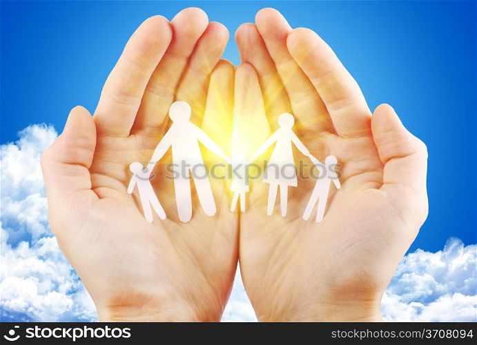 paper family in hand sun and blue sky with copyspace showing freedom or solar power concept