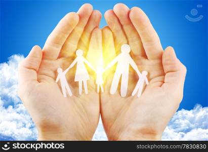 paper family in hand sun and blue sky with copyspace showing freedom or solar power concept