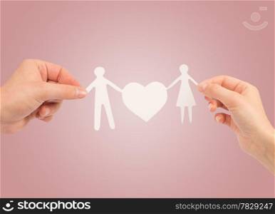 paper family in hands isolated on a white background