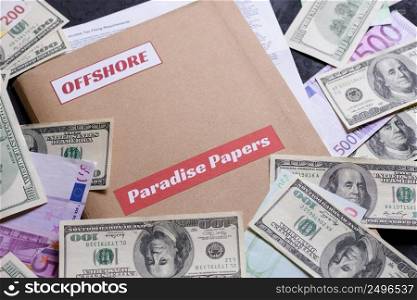 Paper folder with Paradise papers and offshore label on it with european and american currency, offshore tax heaven documents leak concept