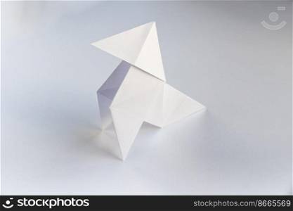 Paper hen origami isolated on a blank white background. Cocotte en papier. Paper hen origami isolated on a white background