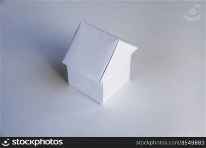Paper house origami isolated on a blank white background.. Paper house origami isolated on a white background