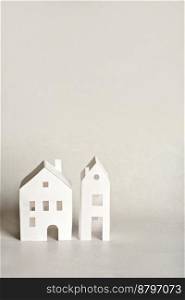 paper houses on light grey background. real estate and development concept. Mortgage insurance and relocation. paper houses on light grey background. real estate and development concept. Mortgage insurance and relocation.