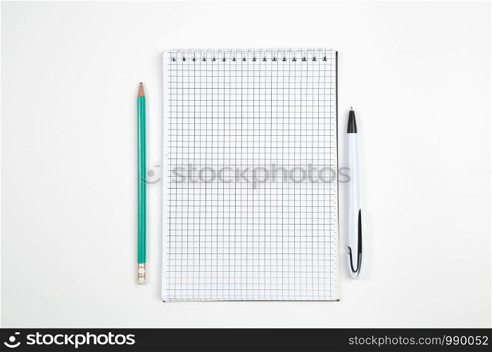 paper notebook with pen or pencil on white isolated background. top view. flat lay . mockup