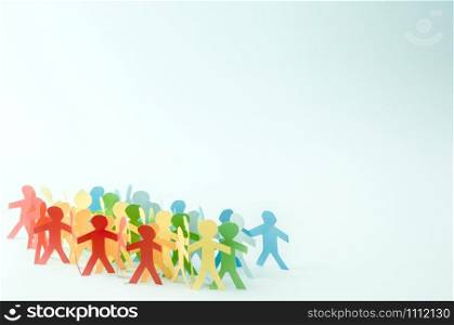Paper people in rainbow colors on blue background