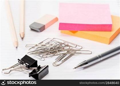 Paper pins with office supplies post-it reminder notes on notepad