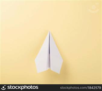 Paper plane letter document message. Top view mock up design of airplane travel tourism, isolated on yellow background with blank empty space for copy space
