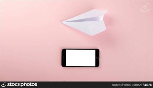 Paper plane letter document message. Top view mock up design of airplane travel and mobile phone, education or innovation origami plane with smartphone blank screen, isolated on pink background
