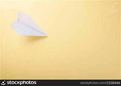 Paper plane letter document message. Top view mock up design of airplane travel tourism, isolated on yellow background with blank empty space for copy space
