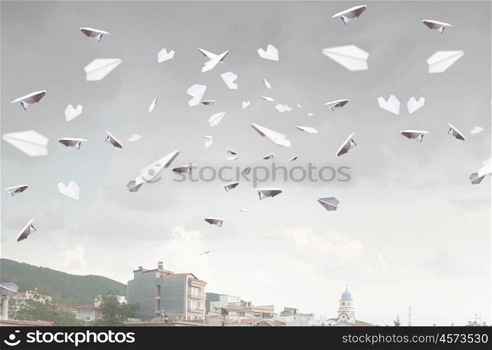 Paper planes flying in air. Outdoor landscape and with flying paper planes