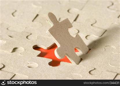 Paper puzzles on a red background. One puzzle is open.