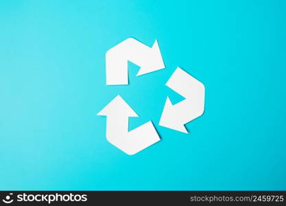 Paper Recycle logo cutout on blue background. Environmental Protection, Zero waste, Reusable, Say No Plastic, World Environment day, Ecology day and Earth day concept.