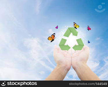 Paper recycle symbol on hand on nature with environment concept