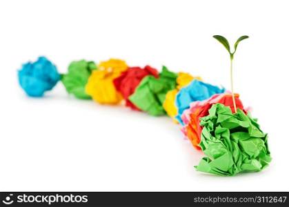 Paper recycling concept with seedlings on white