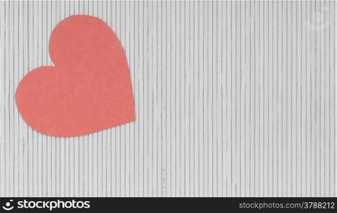 Paper red heart love symbol on grey gray bamboo mat copy space for text as valentines day concept