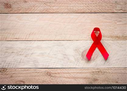 Paper ribbon on the day of World AIDS Day are placed on the wooden floor.