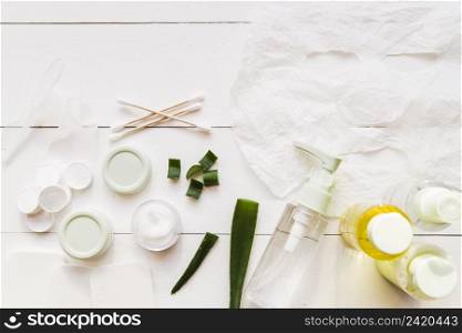 paper sheet face mask cotton swabs moisturizer aloevera white wooden plank