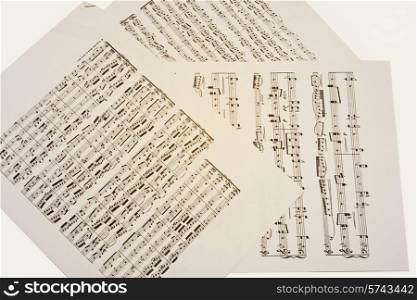 Paper sheets with old musical notes closeup