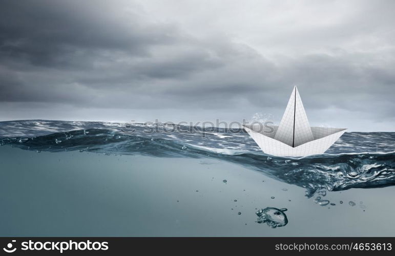 Paper ship. Paper ship floating on water on stormy waves