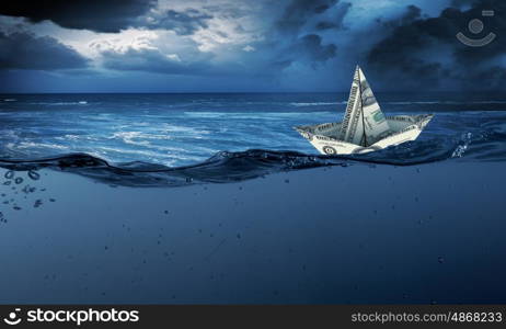 Paper ship. Paper ship floating on water on stormy waves