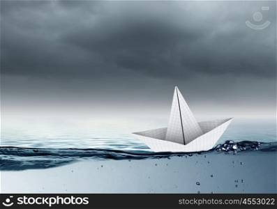 Paper ship. Paper ship floating on water on waves