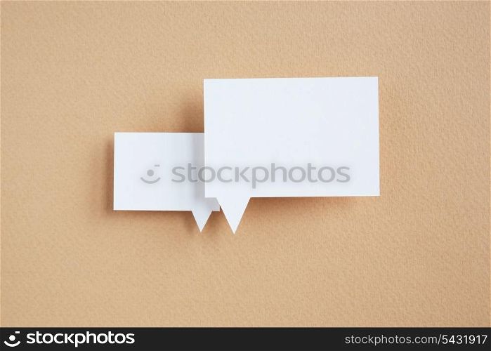 paper speech bubble on brown background
