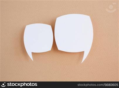 paper speech bubble on brown background