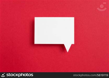 paper speech bubble on red background