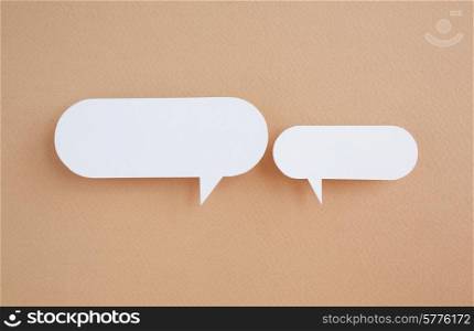 paper speech bubbles on brown background